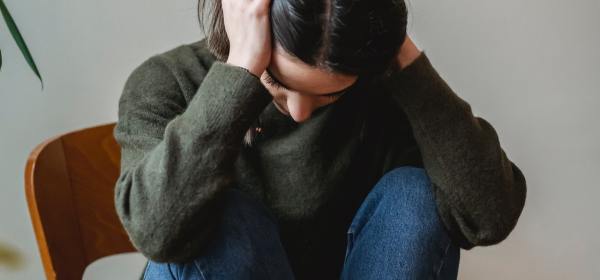 Photo by Liza Summer: https://www.pexels.com/photo/anxious-young-woman-cover-wing-ears-with-hands-sitting-on-chair-6382633/